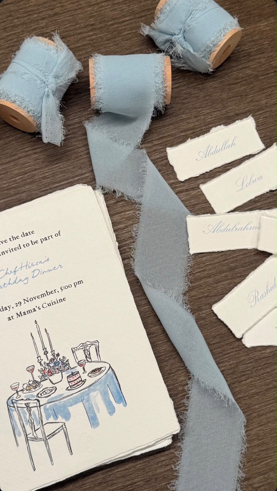 Paper and blue ribbon laid out in the BOW & NOTE studio