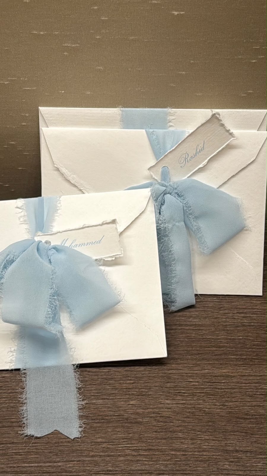 Finished envelopes wrapped with blue ribbon